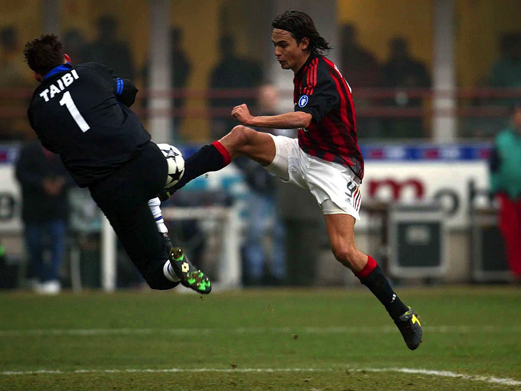 Filippo Inzaghi of AC Milan and Massimo Taibi of Atalanta in action