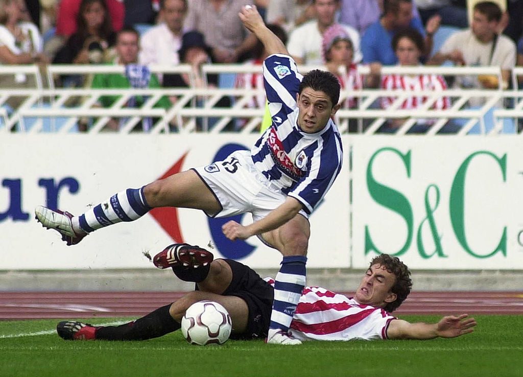 Kahveci Nihat is tackled by Santi Ezquerro
