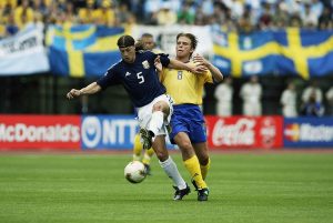 Matias Almeyda of Argentina is tackled by Anders Svensson of Sweden