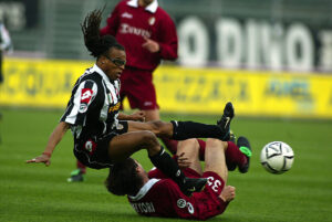 Edgar Davids of Juventus is tackled by Stefano Fattori of Torino