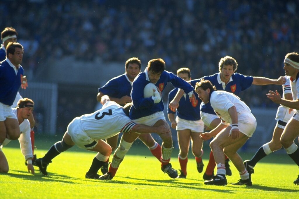 Laurent Cabannes of France is tackled by Jeff Probyn of England
