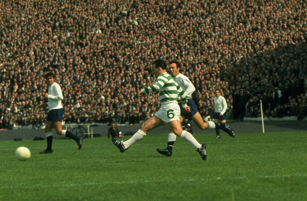 John Clark of Celtic passes the ball as Terry Venables and Jimmy Greaves of Tottenham Hotspur