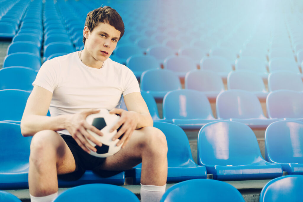 young-athlete-with-soccer-ball-stadium